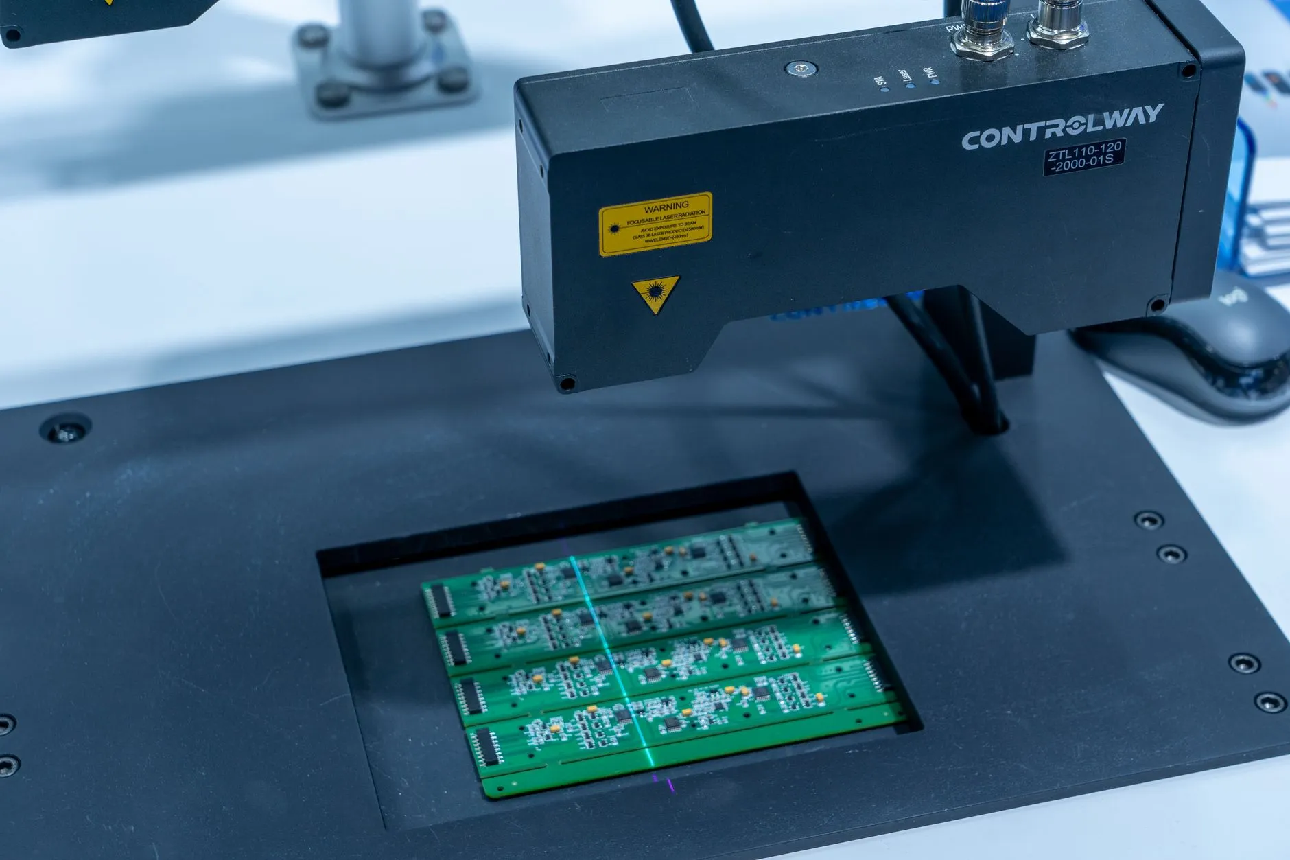 Automated optical inspection machine scanning a printed circuit board at an LED lighting manufacturer