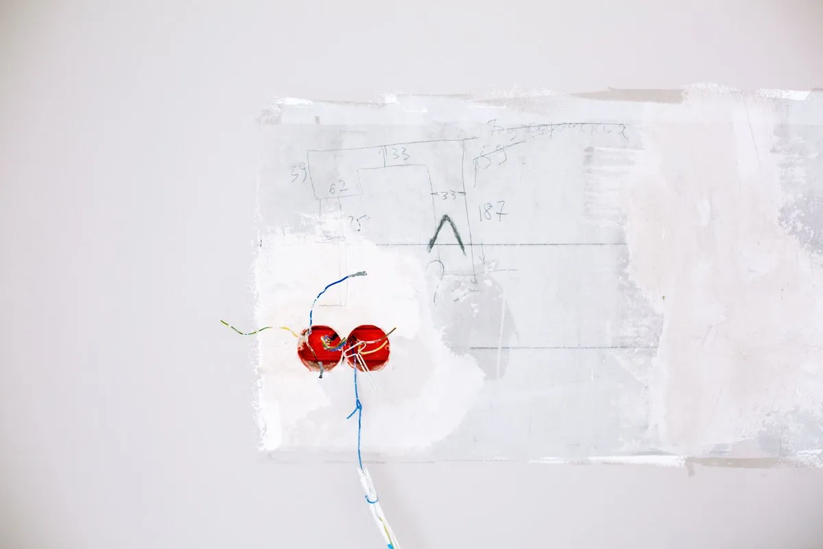 Electrical wiring being installed on a wall during a renovation, showing the mains connections an AU compliant ceiling lamp holder must safely terminate
