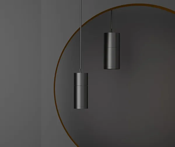 ENCORE decorative pendant luminaires in three finishes, photographed in a hotel interior at night