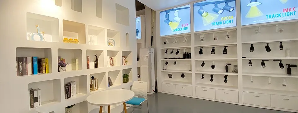 ENCORE showroom wall in Shenzhen displaying finished LED track light heads and product boards, where custom orders are reviewed before a first purchase order