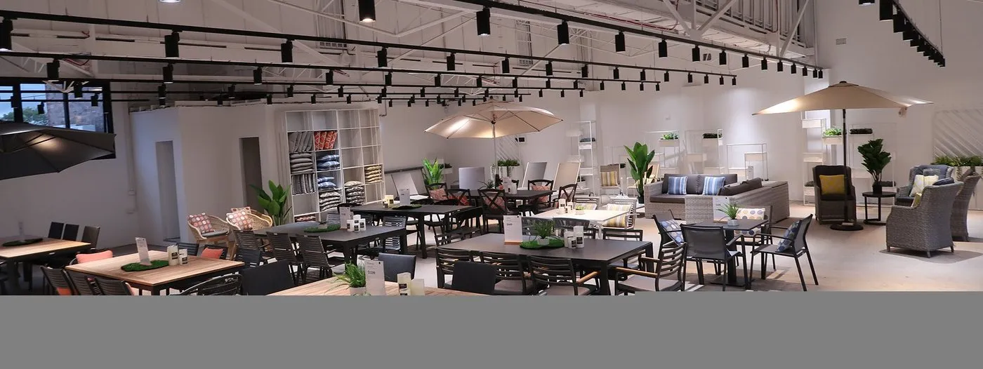 Encore track lighting system installed in a showroom interior showing multiple adapter and head combinations on one rail run