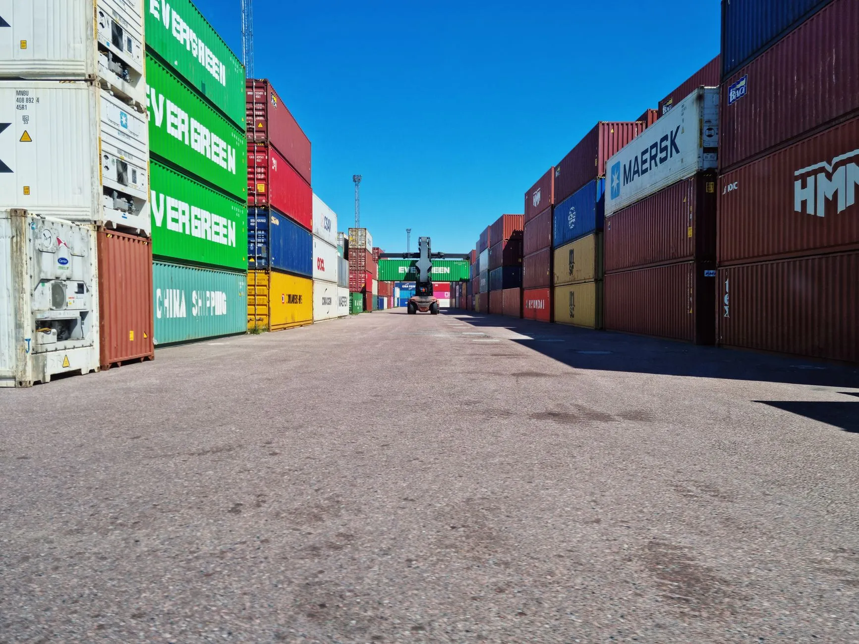Export containers stacked in a logistics yard ready for shipment
