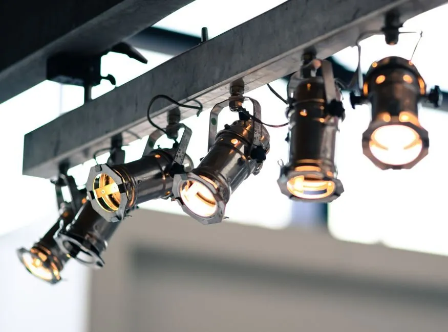 ODM vs OEM LED lighting — an ODM existing-design branded fixture and an OEM custom-built fixture side by side at an ENCORE lighting factory