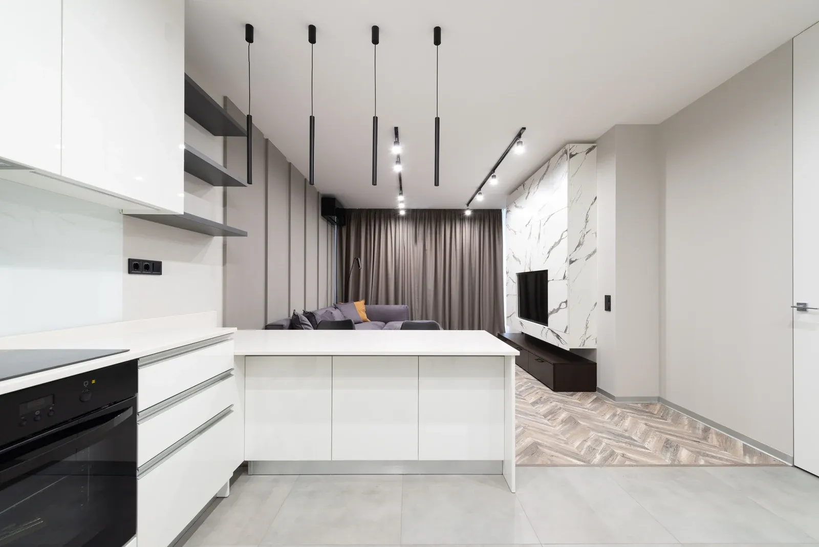 Modern kitchen ceiling with recessed downlights and pendant fixtures, a residential application where downlight cut-out and depth decide the design