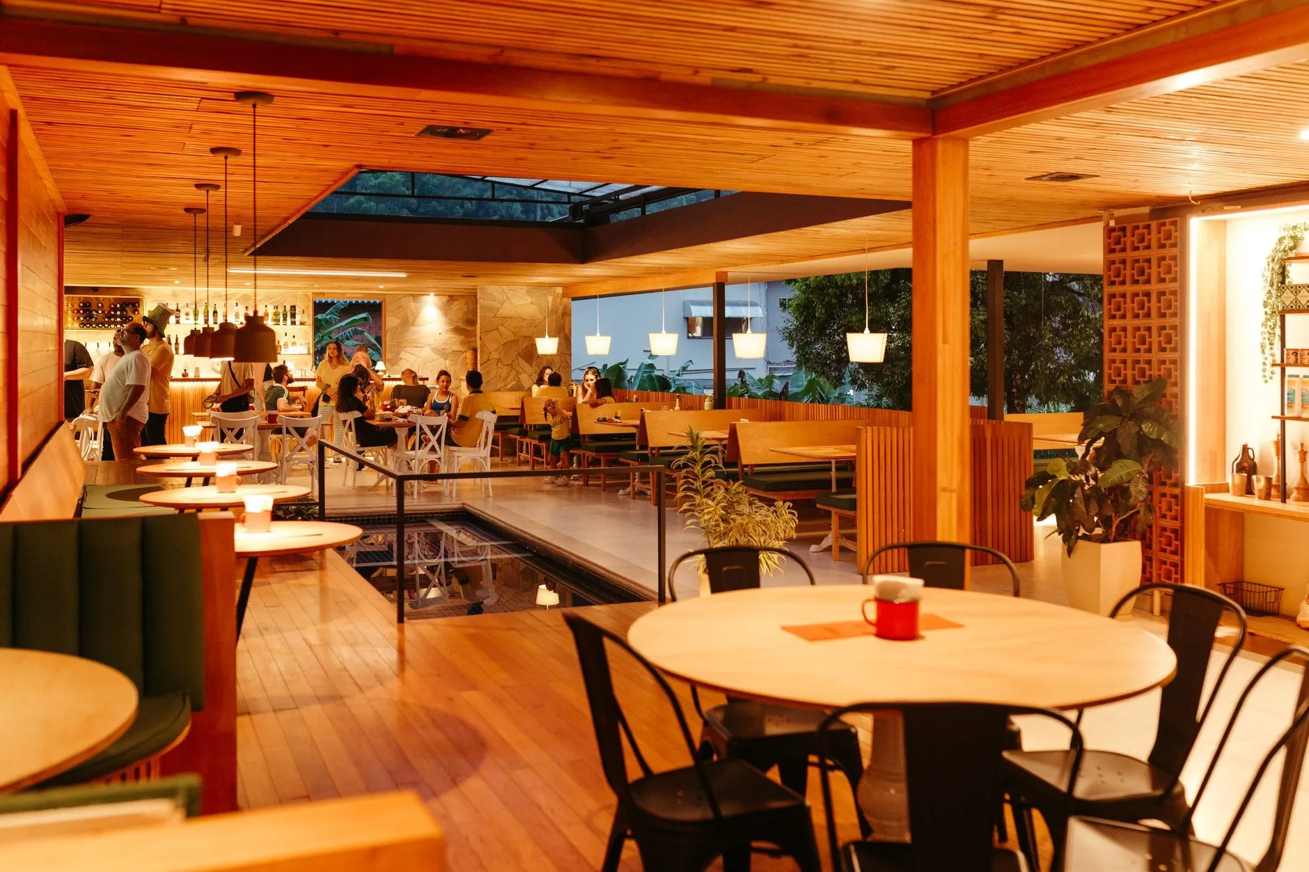 Restaurant interior with warm ambient commercial lighting over timber tables, showing hospitality lighting with high CRI and low colour temperature