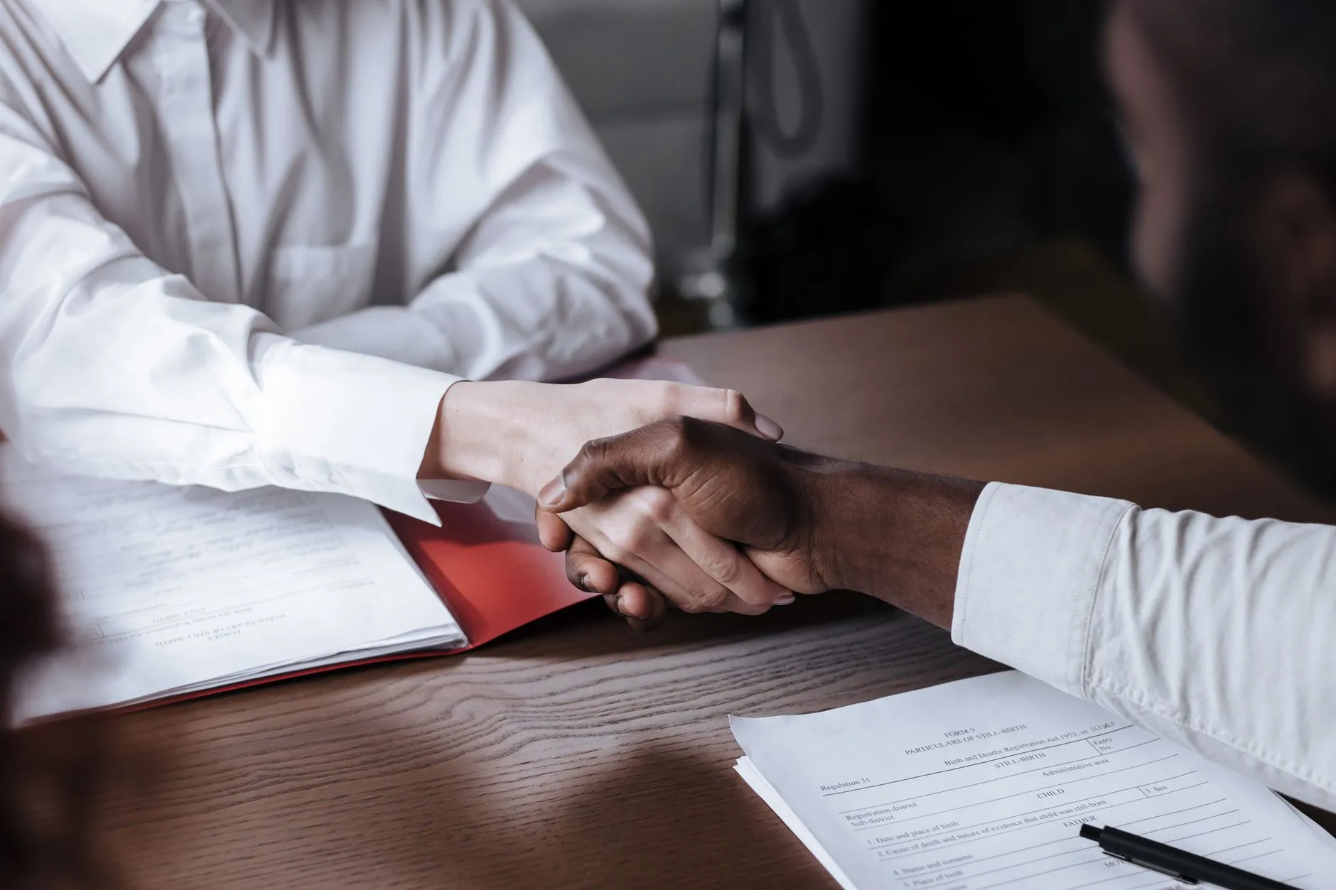 Close-up of a supplier agreement handshake after a lighting factory has passed vetting