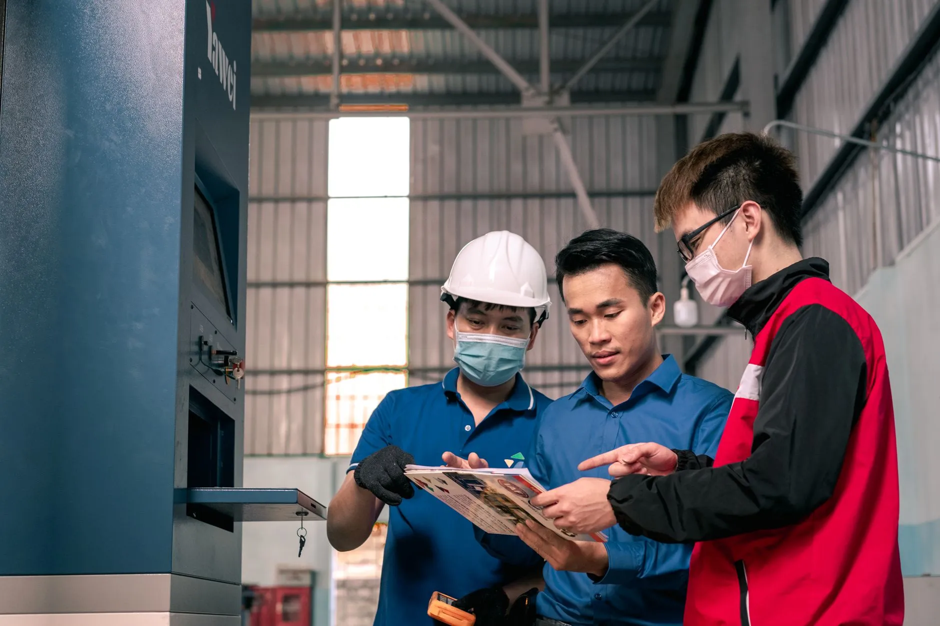 Buyers verifying finished lighting stock against a pick list in a supplier warehouse