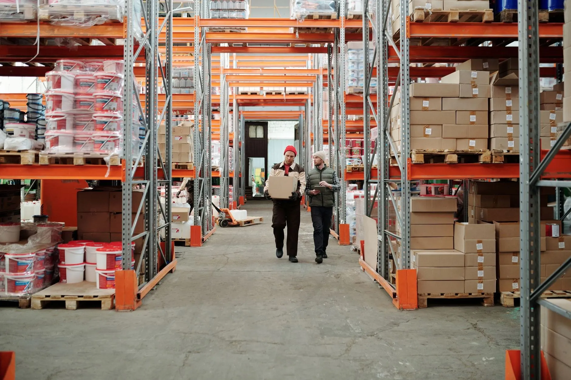 Warehouse aisle with pallet racking and cartons being inspected, where SAA compliant LED lighting orders wait for compliance clearance
