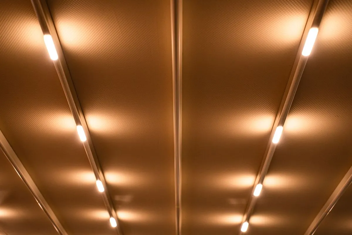 Custom LED lighting light quality — a minimalist warm linear light washing a calm interior, a tasteful custom LED lighting atmosphere from a real space