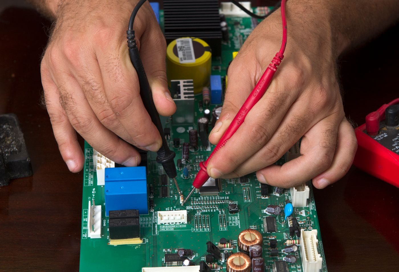Close-up of precision circuit-board inspection for LED driver electronics