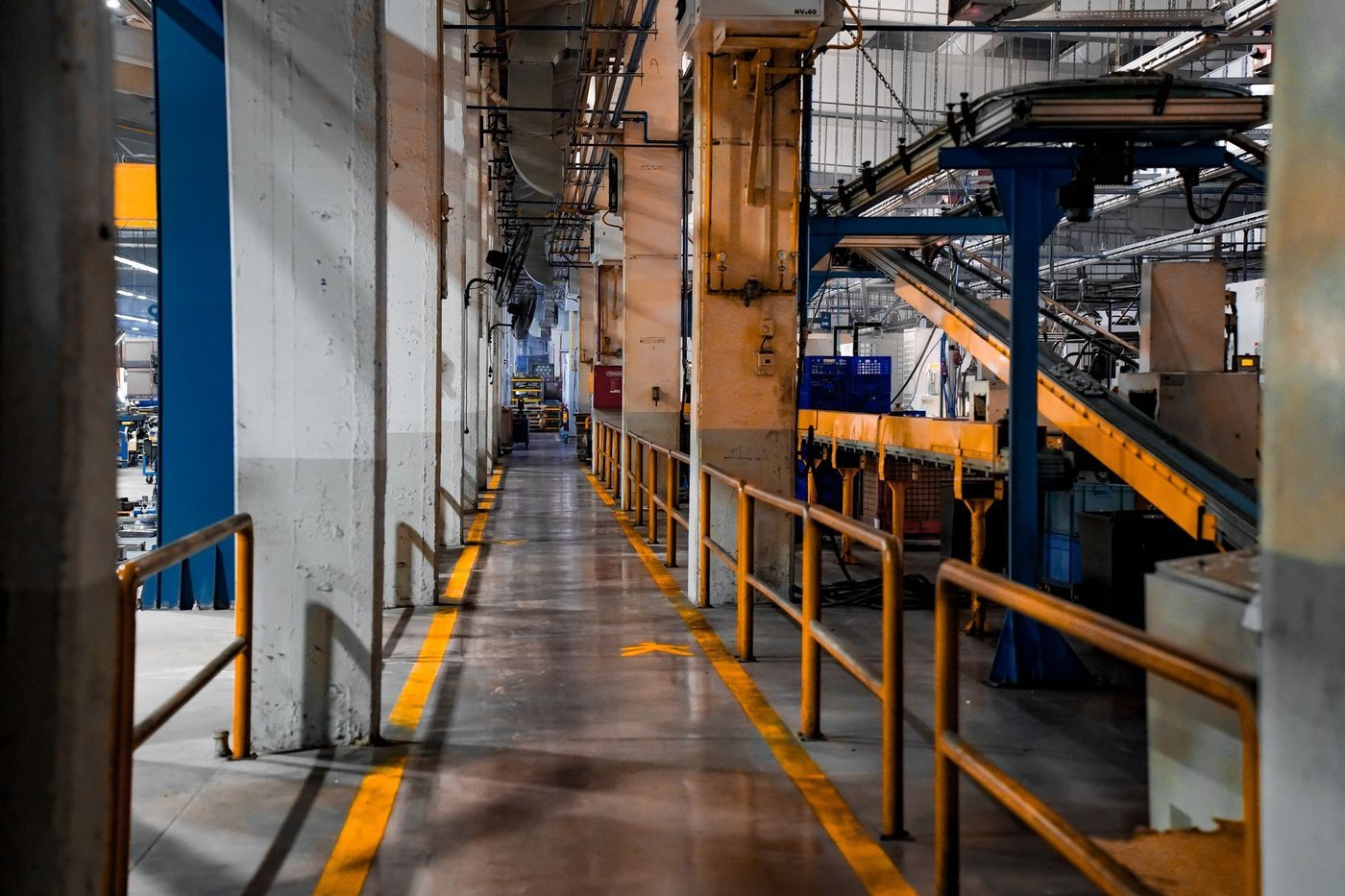 A wide view of a modern lighting factory production floor with organised lines and process walkways