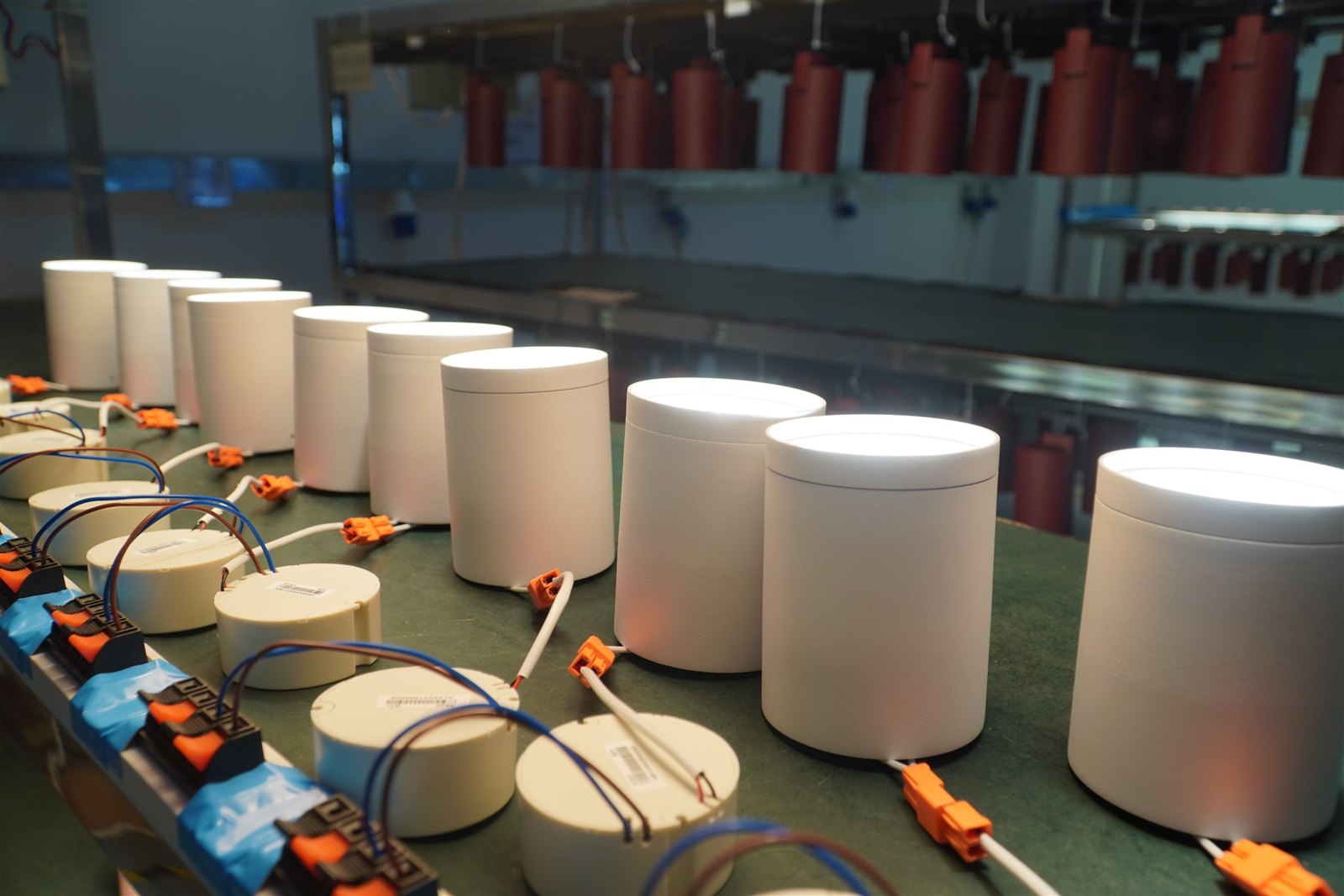 Finished LED downlights on an aging line at ENCORE, running under load before packing