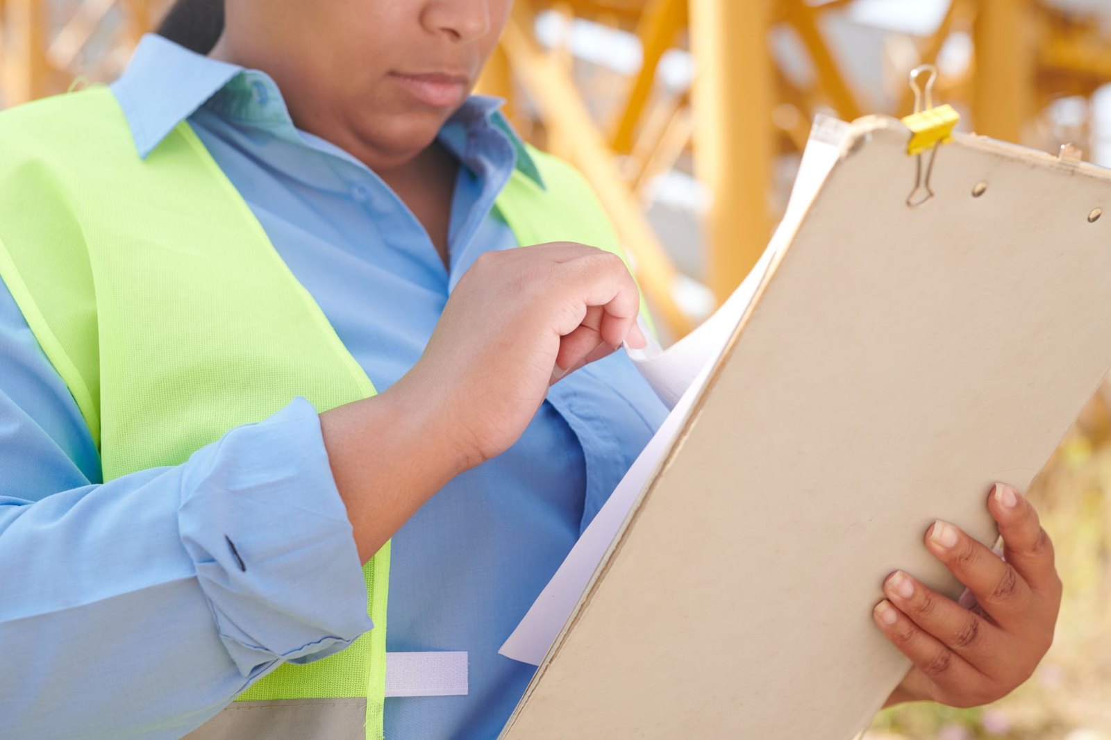 An inspection checklist and product documents being reviewed on a clipboard — the paper trail a sampling plan produces